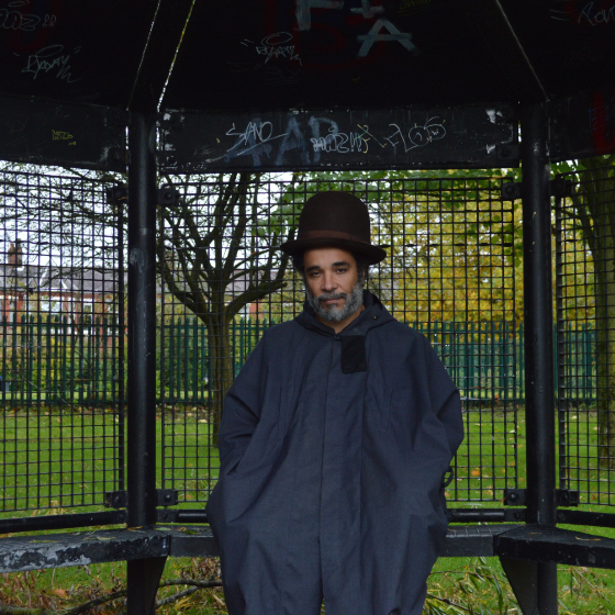 An image of Andrew Ibi standing in a shelter in a park.