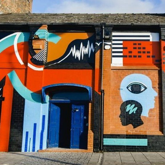 The exterior of the Zanzibar venue in Liverpool with bright, colourful wall art painted on the walls.