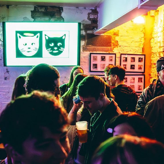 A group of people enjoying a social gathering at an indoor venue with exposed brick walls