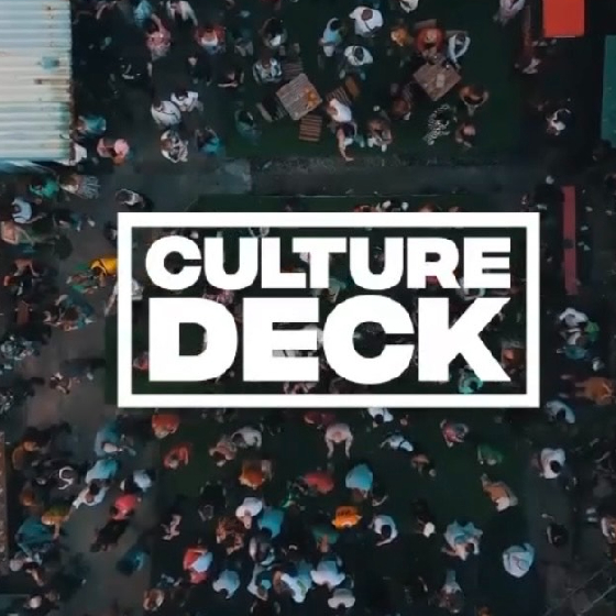 Aerial view of a crowded street scene with white text overlay that reads "CULTURE DECK."