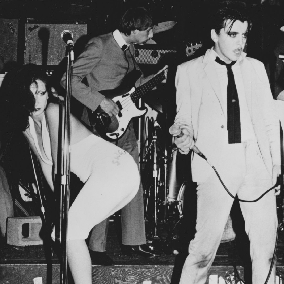 A black and white image of Deaf School musical band performign on stage