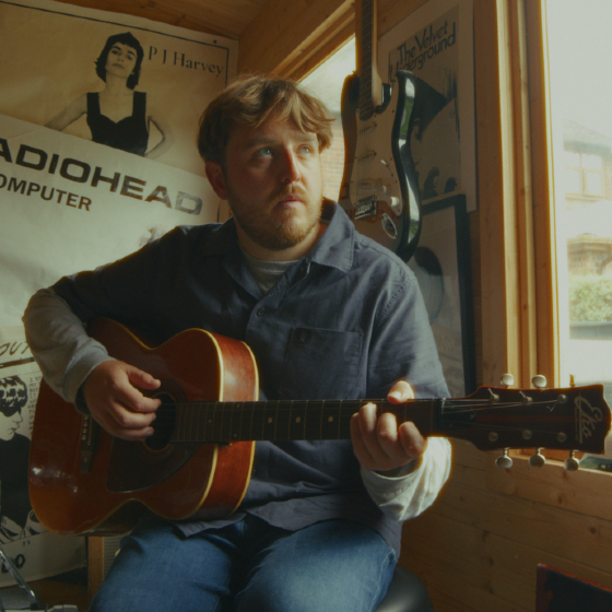 An image of a man with a guitar