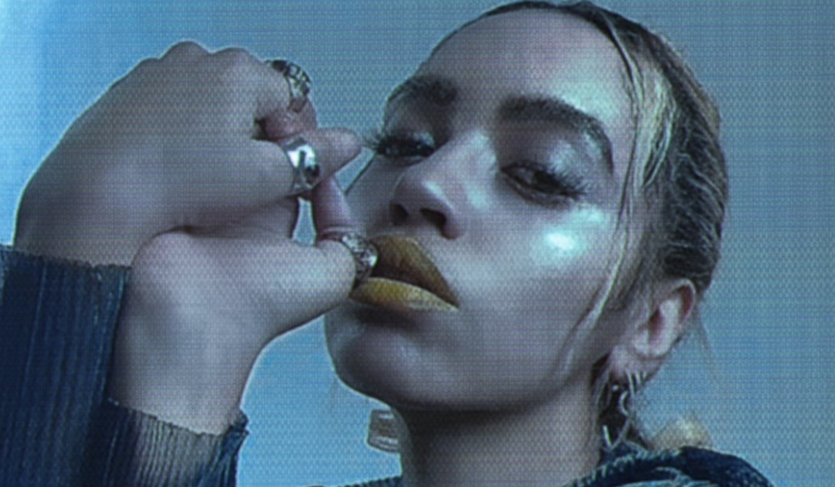 An image of Jetta holding both hands near her face