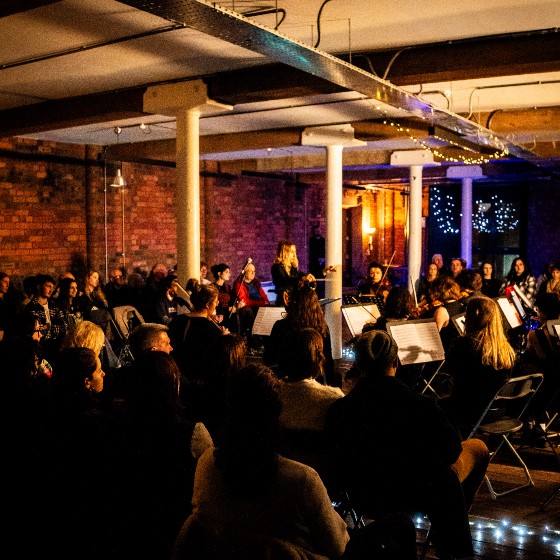 An orchestra in a dimly lit room