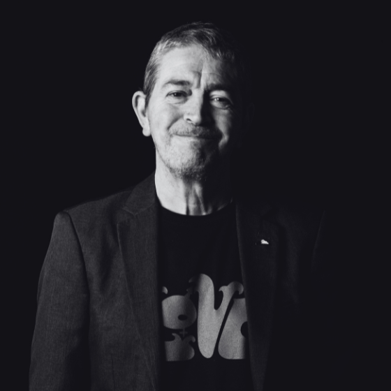 A person wearing a t-shirt on black background. 